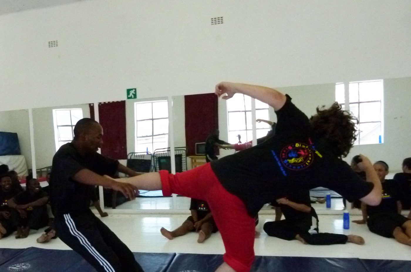 Two trainees practising a fight sequence on the mats