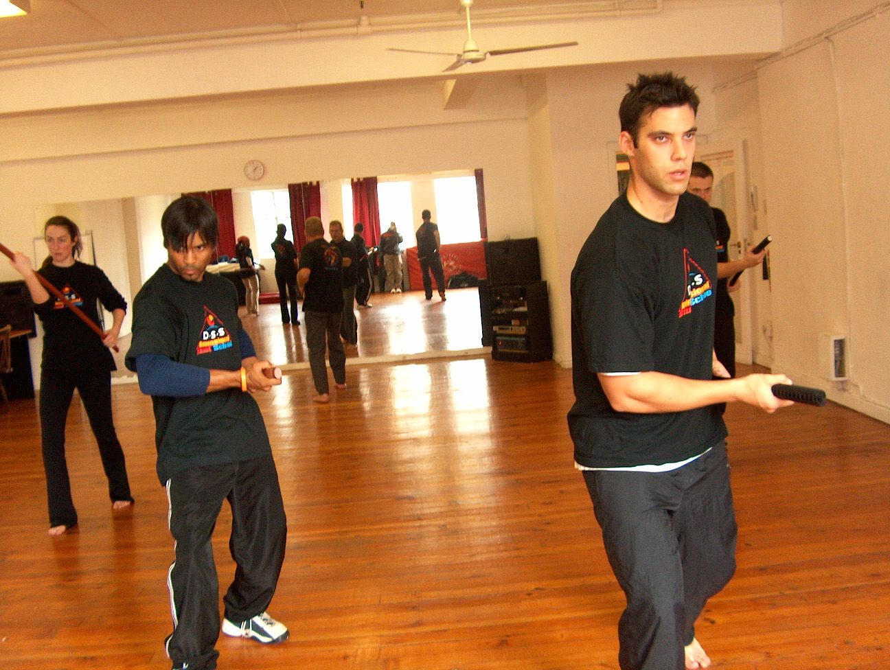 Trainees practising sword work in a studio