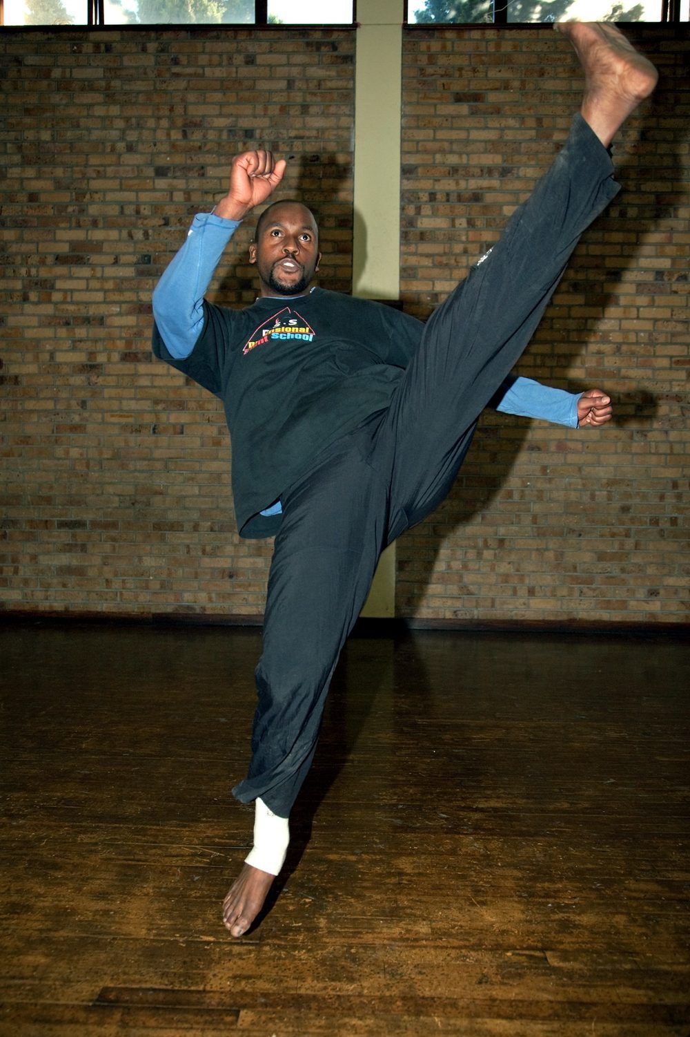 Sensei San Ndlovu performing an axe kick in the dojo