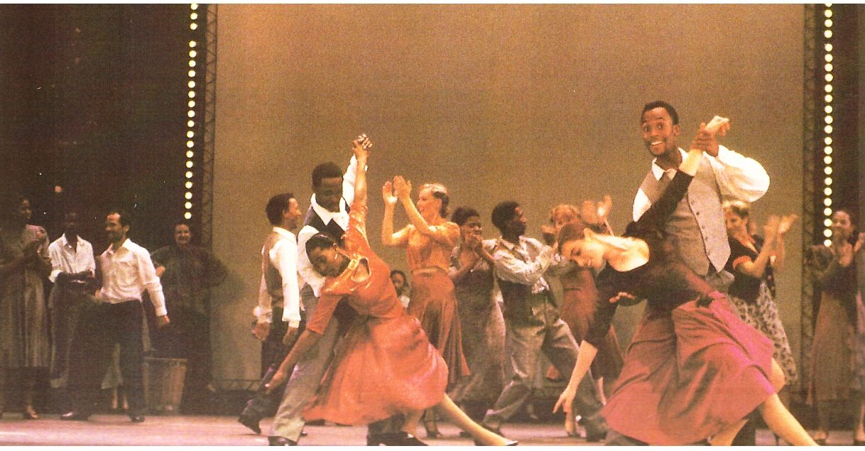 A full company on stage at the Playhouse, dancers mid-turn, at the Night of 100 Stars