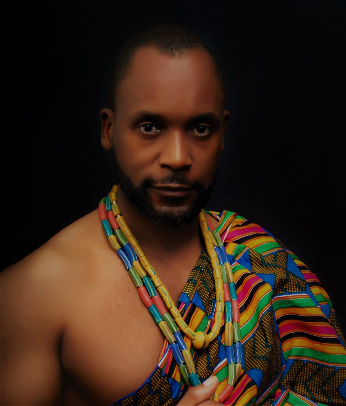 Portrait of Sensei San Ndlovu in traditional kente cloth and beads