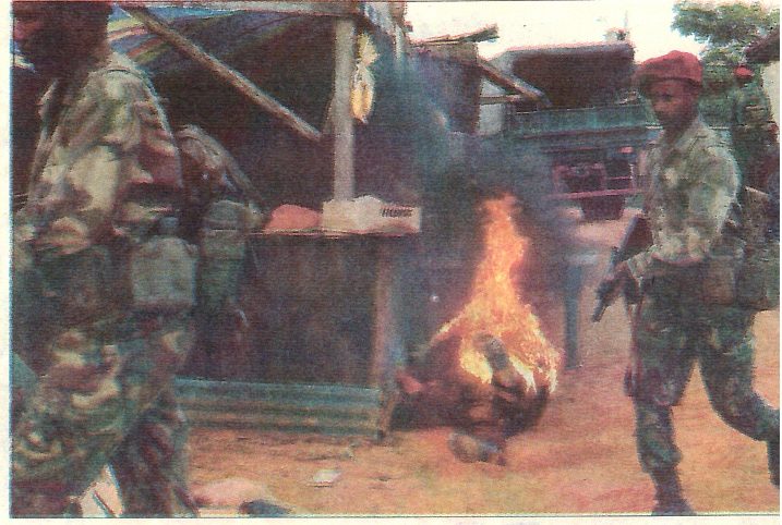 A fire stunt on the set of Third World, with performers in army uniform