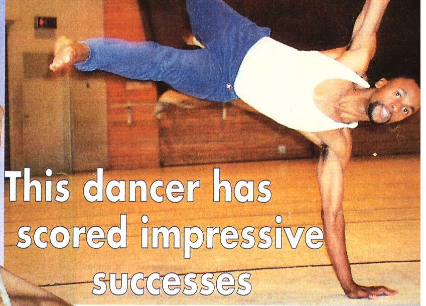Sensei San Ndlovu in a one-arm balance in the studio, with the deck: This dancer has scored impressive successes
