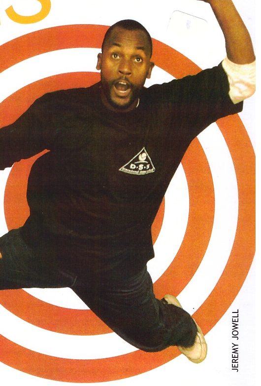 Sensei San Ndlovu leaping in front of an orange target design