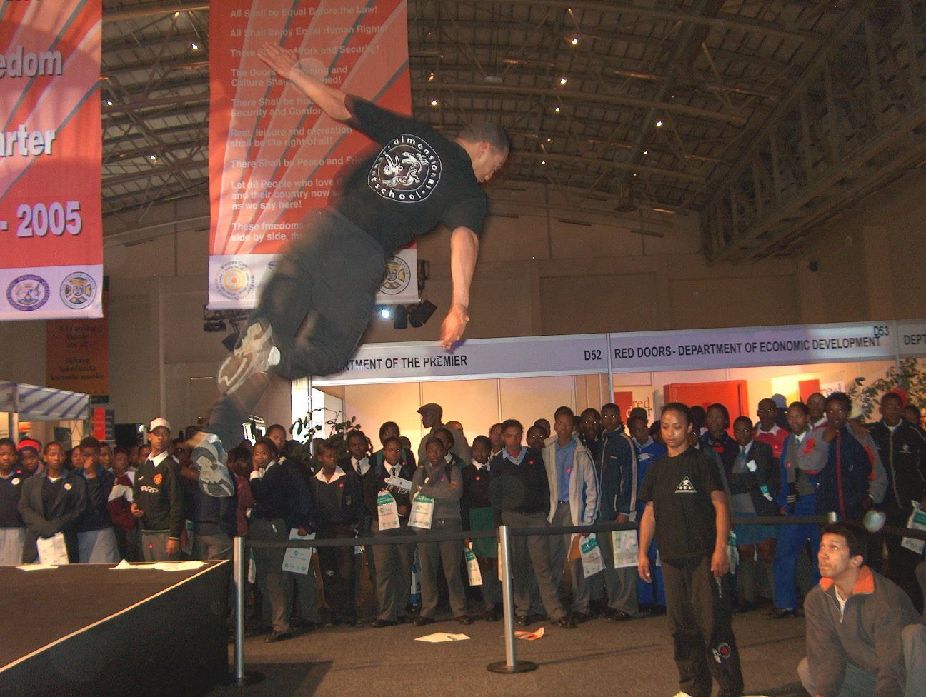 A performer leaping across a stage at the SABC Career Fair, 2005