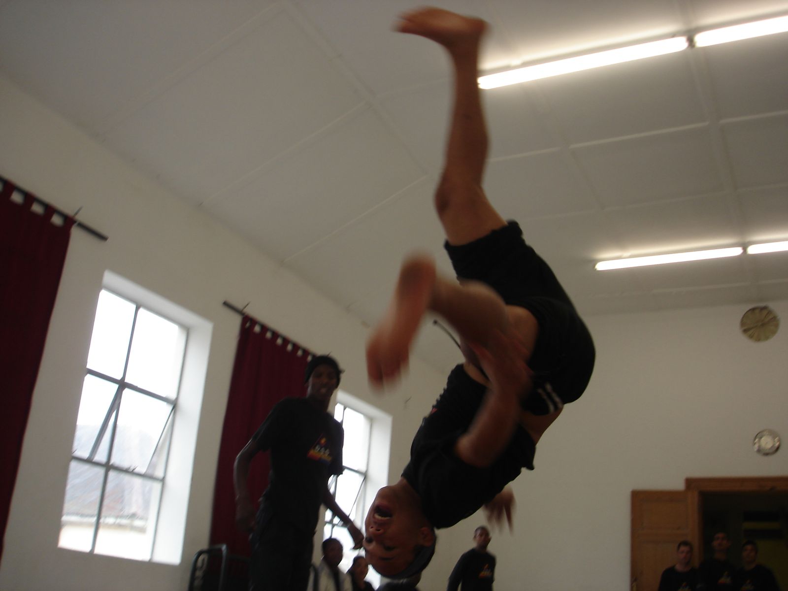 A trainee in a back flip above the crash mats