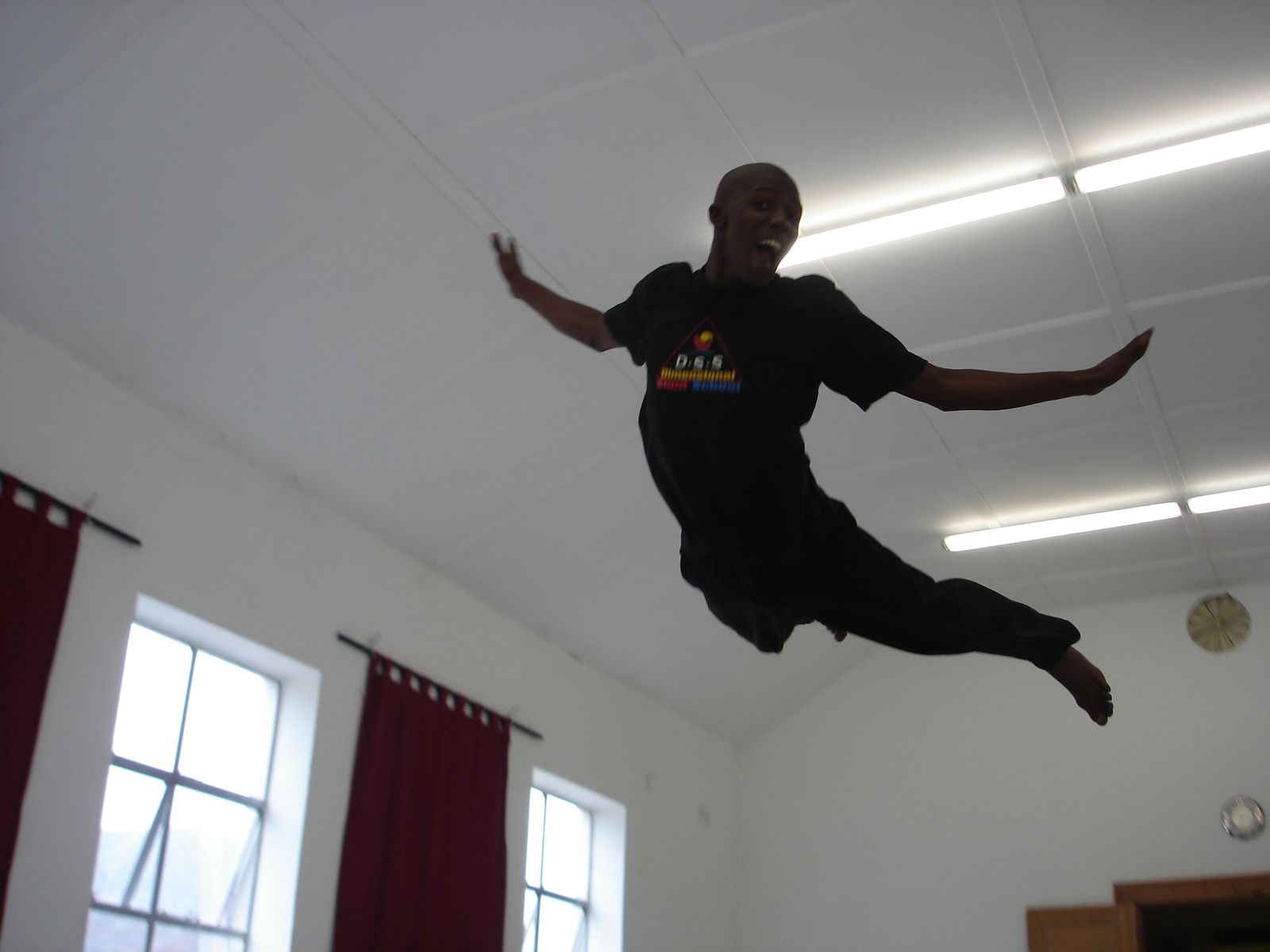 A trainee diving horizontally through the air in the training hall