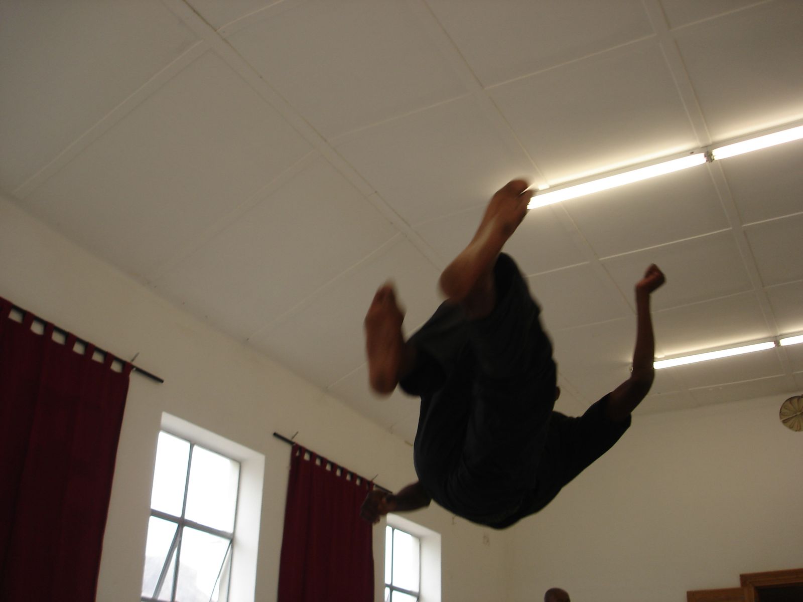 A trainee mid-somersault in the training hall